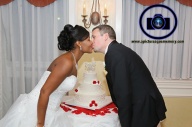 kiss over cake at bridgewater manor wedding photos by NJ wedding photographer apicturesquememoryphotography